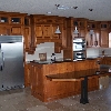 Stained maple kitchen, granite counter tops, with a table height island drop down.